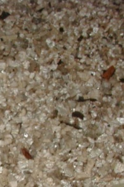 A close up view of asbestos in someone's wall.