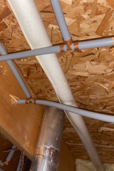 Poly B Piping in someone's wall of their home.