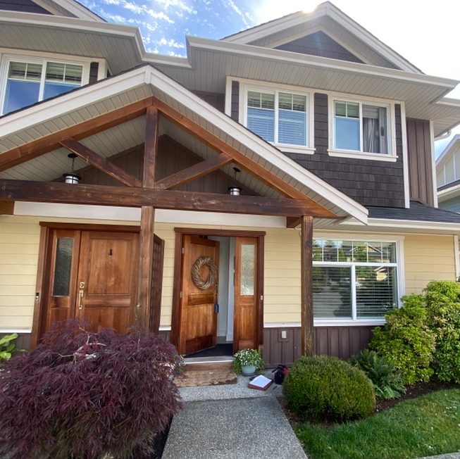 A duplex in brown and cream paints with wood accents.